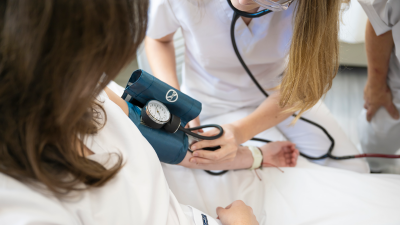 Healthcare professional checking a patient's blood pressure using a sphygmomanometer.