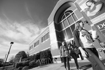 Black and white photo of high school students walking on Davie Campus