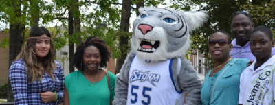 Group of people stand with DCCC mascot Stormy.