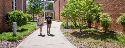 Two students walking outside.