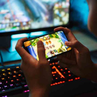 Student playing phone game in dark room