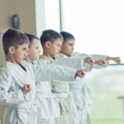 young karate students in white uniforms