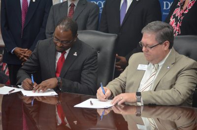 Dr. Anthony Graham and Dr. Darrin Hartness sign 2 +2 agreement.