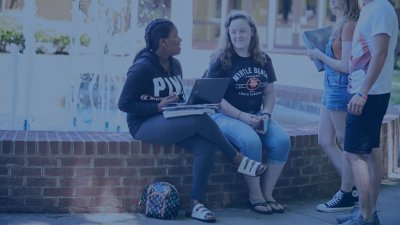 Four Students hanging out by the DCCC Fountain