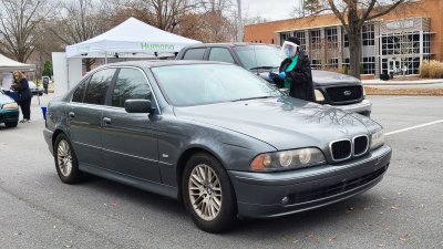 volunteer gathering information from driver of car