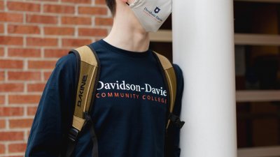 Close up on male student wearing Davidson-Davie Community College Shirt