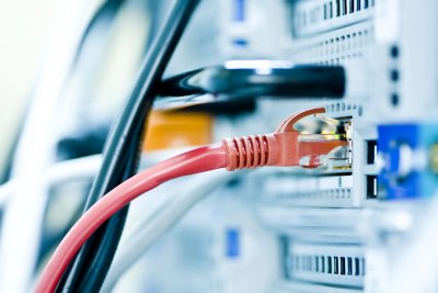 Red Ethernet cable plugged into network hardware