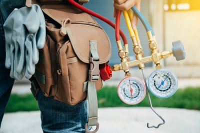 HVAC Technician lower torso holding technical guages