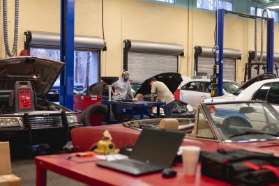 Automotive Maintenance Shop with students looking at car in background
