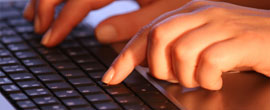 hands typing on keyboard