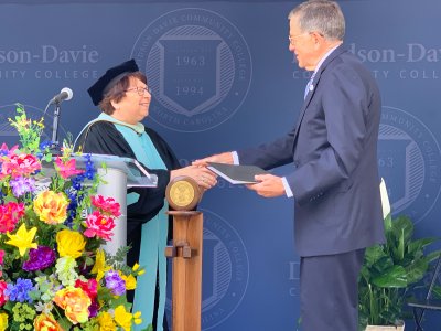 Burr Sullivan receiving honorary degree on commencement stage