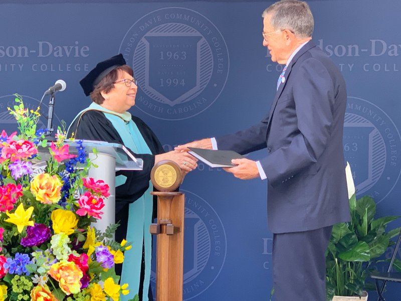 Burr Sullivan receiving honorary degree on commencement stage