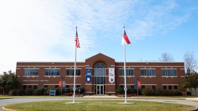Davie Campus Community Building with flag poles in front