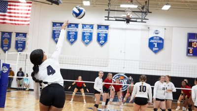 Volleyball Player serving ball