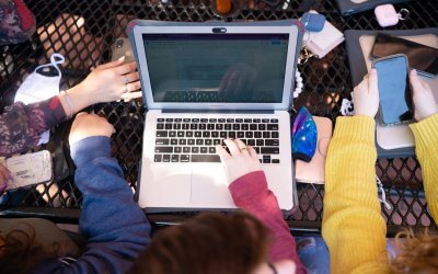 Closeup of students' laptop and hands