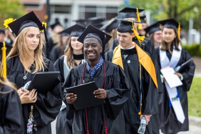 Group of graduates walking in a line after graduating
