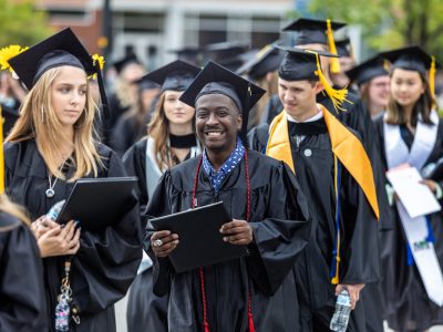 Group of graduates walking in a line after graduating