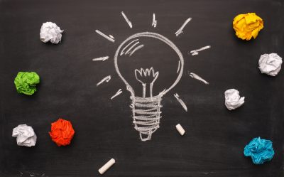 A Lightboard drawn on chalkboard with balled up colorful paper