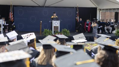 Graduation ceremony from behind the perspective of the graduates caps.