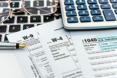 Tax documents and calculator on table top