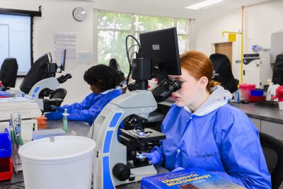 Medical Laboratory Technology Student uses microscope.