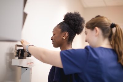 Medical Assisting students check vitals.