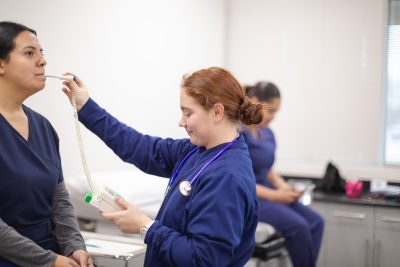 Medical Assisting students check vitals.