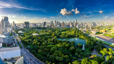 Sunset scence of modern office buildings and condominium in Bangkok city downtown with sunset sky and clouds at Bangkok , Thailand. Lumpini park