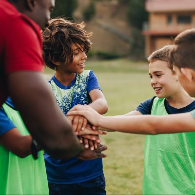 Young children in Sports huddle