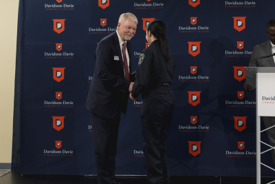 Major Ronnie Phillips, seen here congratulating one of the 15 graduates during the ceremony.