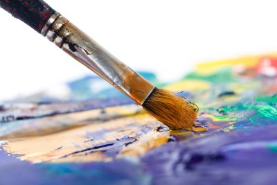 Close up of paint brush painting on a canvas