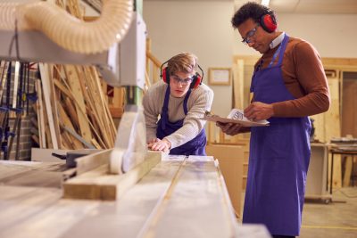 Young men doing carpentry work in wood shop