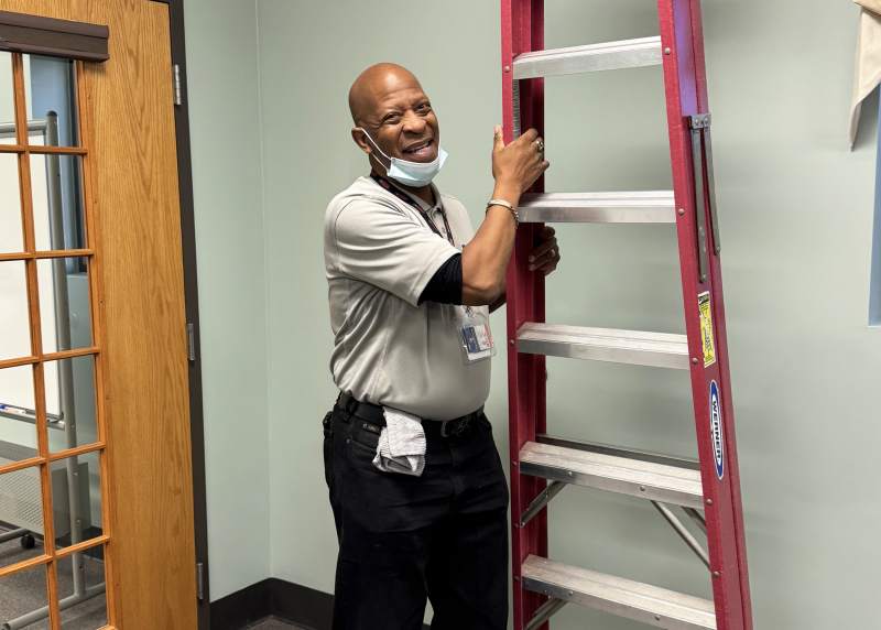 William Pass changing light bulbs at The Life Center (Lexington)