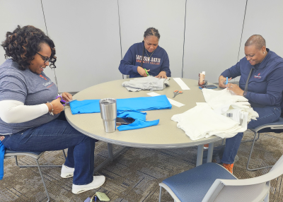 April Edmond, Jasmine Hargrave, and Angie Mack.(left to right) making tote bags to donate to local service agencies (Thomasville).