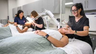 People receiving facial treatments in a spa-like setting.