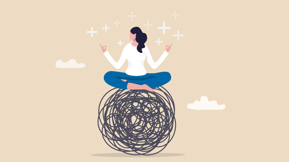 A person meditating on a ball of tangled scribbles with sparkles around their hands.