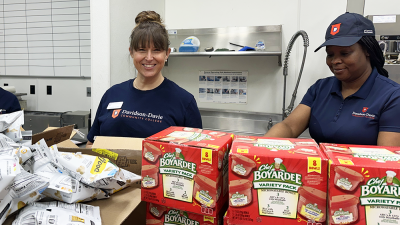 Staff packing food bags for children at Hopefulls Backpack Program.