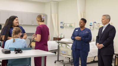 North Carolina Governor Josh Stein talks with students and faculty in a clinical simulation room.