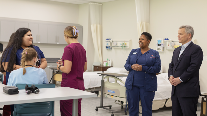 North Carolina Governor Josh Stein talks with students and faculty in a clinical simulation room.