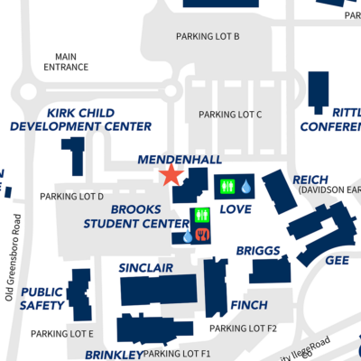 Campus map showing key buildings, parking lots, and facilities with labeled icons and pathways.