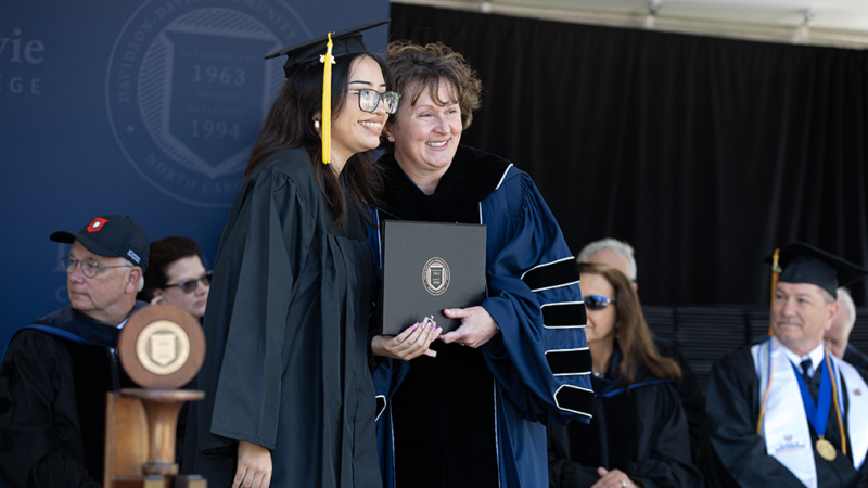 Davidson-Davie Community College President, Jenny Varner, presents student with degree.