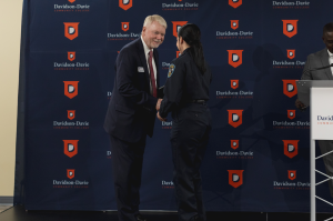 Major Ronnie Phillips, seen here congratulating one of the 15 graduates during the ceremony.